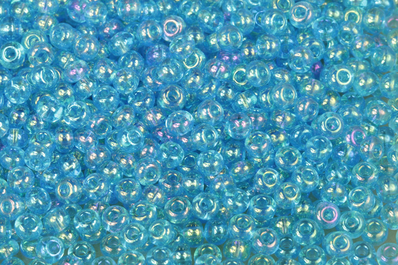 Rokajl Preciosa 6/0 (3,7 - 4,3 mm) RH, bal. 50 g - transparentní akvamarín, rainbow