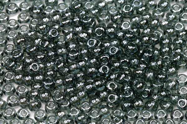 PRECIOSA rokajl 6/0 (3,7 - 4,3 mm) RH, bal. 50 g - transp. šedá s listrem, sfinx