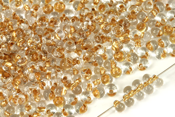 PRECIOSA™ Drops 5/0 (4,6 mm), bal. 20 g - krystal se zlatým průtahem