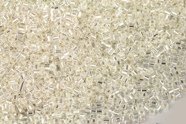 PRECIOSA™ dvoukrátky (2cuts) 10/0 (2,0 - 2,2 mm) RH, bal. 50 g - krystal, stříbrný průtah