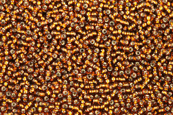 Rokajl Preciosa 10/0 (2,2 - 2,4 mm) RH, bal. 50 g - transp. tmavší topaz, SL (hnědá)