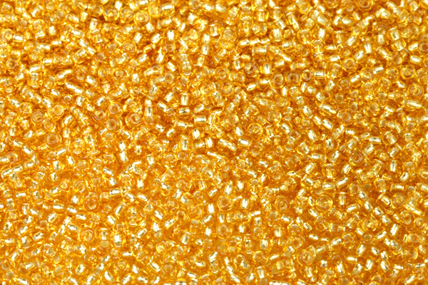 PRECIOSA rokajl 10/0 (2,2 - 2,4 mm) RH, bal. 50 g - transp. topaz, SL (zlatá)