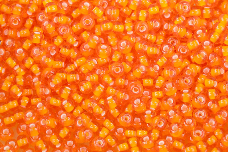 PRECIOSA rokajl 6/0 (3,7 - 4,3 mm) RH, bal. 50 g - transp. oranžová, bílý průtah