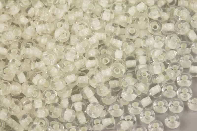 Rokajl Preciosa 5/0 (4,3 - 4,8 mm) RH, bal. 50 g - krystal s bílým průtahem, svítící