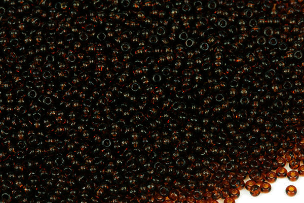 Rokajl Preciosa 10/0 (2,2 - 2,4 mm) RH, bal. 50 g - transp. tmavý topaz