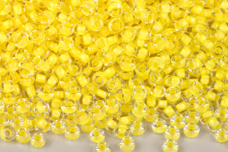 PRECIOSA rokajl 6/0 (3,7 - 4,3 mm) RH, bal. 50 g - krystal se žlutým průtahem