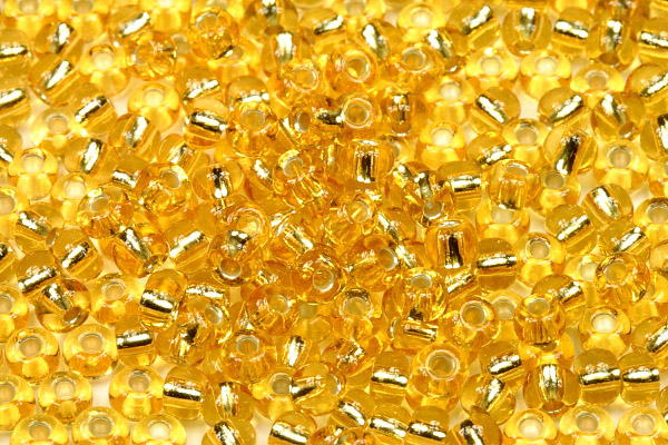 PRECIOSA rokajl 5/0 (4,3 - 4,8 mm) RH, bal. 50 g - transp. topaz, SL (zlatá)