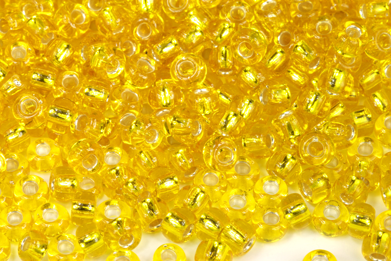 PRECIOSA rokajl 3/0 (5,3 - 5,8 mm) RH, bal. 50 g - transparentní žlutá, SL