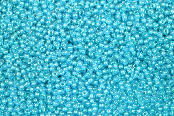 PRECIOSA rokajl 10/0 (2,2 - 2,4 mm) RH, bal. 50 g - transp. akvamarín, modrý vtah, sfinx