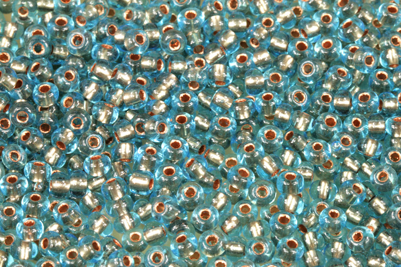 PRECIOSA rokajl 6/0 (3,7 - 4,3 mm) RH, bal. 50 g - transp. akvamarín, bronzový vtah