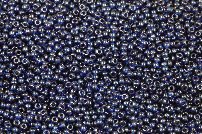 PRECIOSA rokajl 10/0 (2,2 - 2,4 mm) RH, bal. 50 g - transp. tmavý akvamarín, modrá