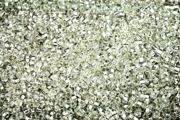 PRECIOSA rokajl 11/0 (2,0 - 2,2 mm) SH, bal. 50 g - krystal se stříbrným průtahem, SL