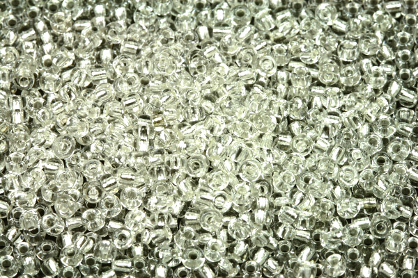 PRECIOSA rokajl 8/0 (2,8 - 3,2 mm) RH, bal. 50 g - krystal se stříbrným průtahem, SL