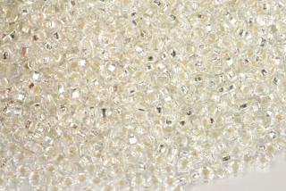 PRECIOSA rokajl 8/0 (2,8 - 3,2 mm) SH, bal. 50 g - krystal se stříbrným průtahem, SL