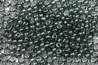 PRECIOSA rokajl 6/0 (3,7 - 4,3 mm) RH, bal. 50 g - transp. šedá s listrem, sfinx