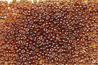 PRECIOSA rokajl 11/0 (2,0 - 2,2 mm) RH, bal. 50 g - transp. topaz (hnědá) s listrem, sfinx