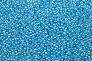 PRECIOSA rokajl 10/0 (2,2 - 2,4 mm) RH, bal. 50 g - transp. akvamarínově modrá, rainbow