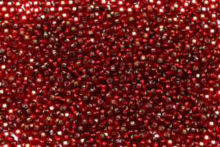 PRECIOSA rokajl 10/0 (2,2 - 2,4 mm) RH, bal. 50 g - transp. rubínově červená, SL