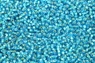 PRECIOSA rokajl 11/0 (2,0 - 2,2 mm) SH, bal. 50 g - transp. akvamarínově modrá, SL