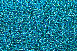 PRECIOSA rokajl 11/0 (2,0 - 2,2 mm) RH, bal. 50 g - transp. akvamarínově modrá, SL