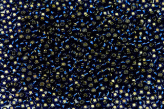 PRECIOSA rokajl 10/0 (2,2 - 2,4 mm) RH, bal. 50 g - transp. tmavá akvamarínově modrá, SL
