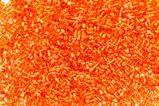 PRECIOSA Delica-RH, válečky 1,3x1,3 mm, bal. 50 g - transp. oranžová (hyacint), SL