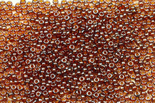 PRECIOSA rokajl 11/0 (2,0 - 2,2 mm) RH, bal. 50 g - transp. topaz (hnědá) s listrem, sfinx