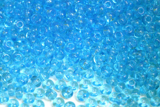 PRECIOSA rokajl 6/0 (3,7 - 4,3 mm) RH, bal. 50 g - transp. akvamarínově modrá